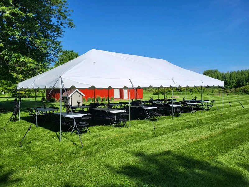 Tent in front of red barn